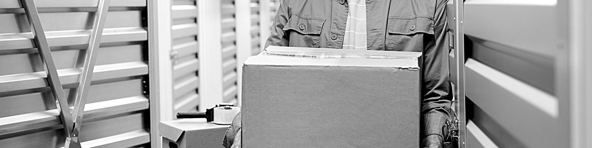 Guy carrying boxes to storage unit